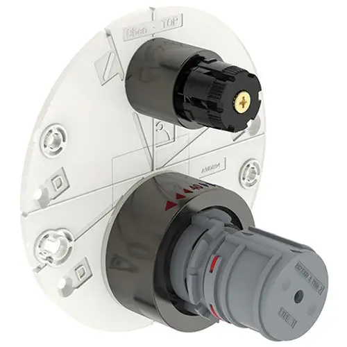 Ideal Standard Produktabbildung einer Badethermostat-Attrappe mit einem runden Gehäuse, zwei Drehknöpfen und einer transparenten Abdeckplatte zur Montage.